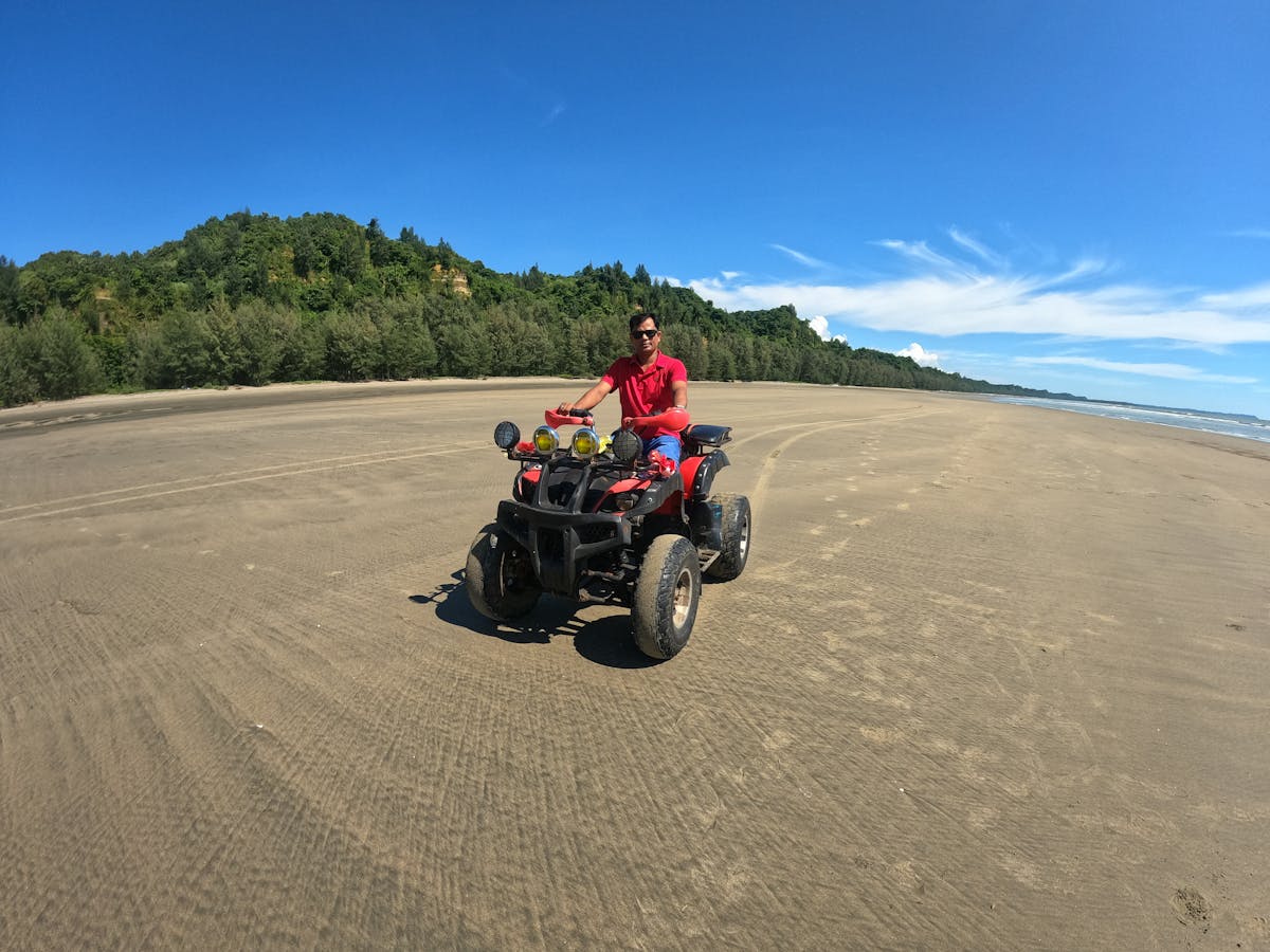Ridef navigating a powerful ATV through muddy off-road trails in Goa, splashing dirt and enjoying an adernaline-filled adventure