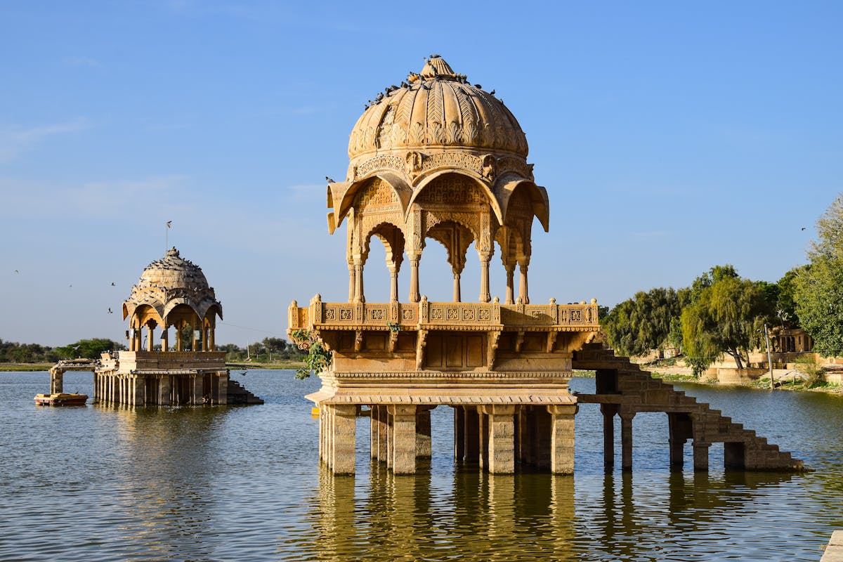 Gadisar Lake in Jaisalmer, Rajasthan with Historic chhatris and Temple reflections during Sunrise