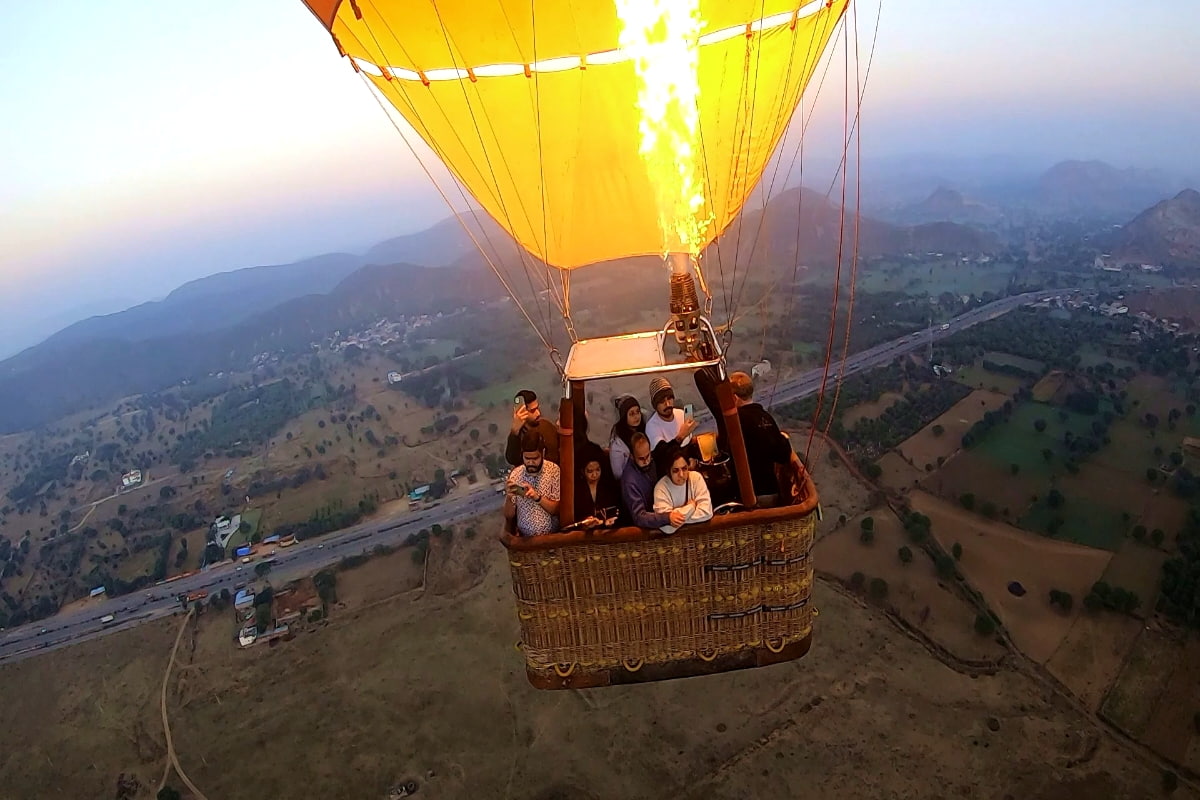 Hot air balloon flying over Jaipur’s forts and countryside during sunrise