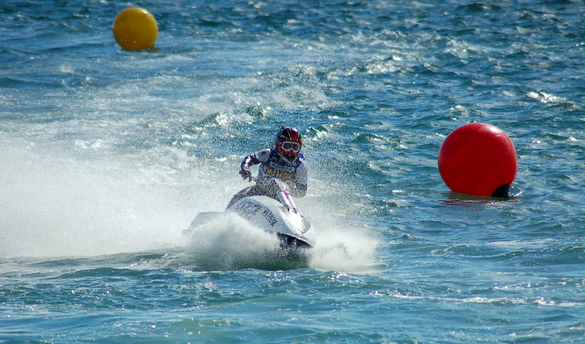 Person Enjoying a thrilling jet ski ride on the waves of a sunny beach in Goa, Showcasing speed and Adventure