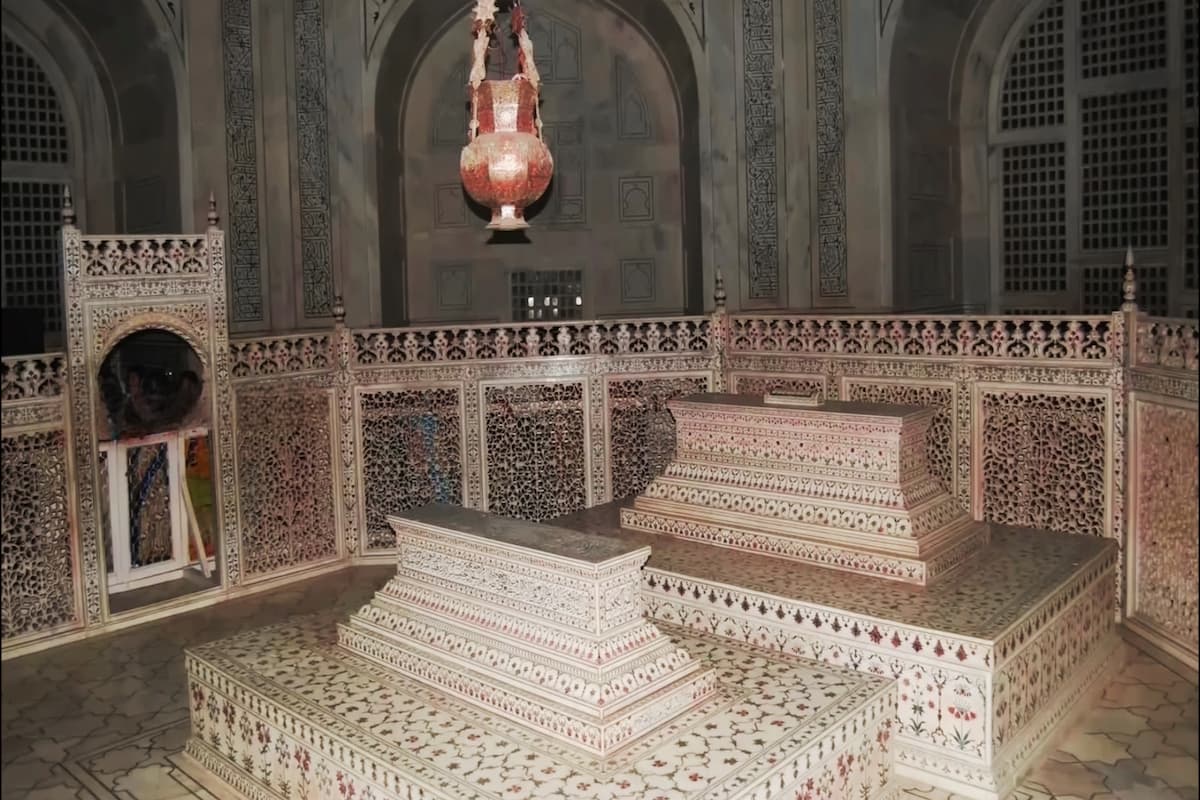Inside view of the Taj Mahal showing floral marble carvings and cenotaph under the central dome