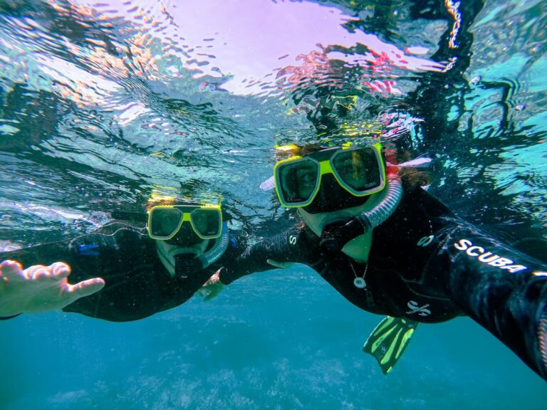 Snorkeler diving beneath the clear waters of goa, surrounded by colorful fish and coral reefs, Exploring the vibrant marine life